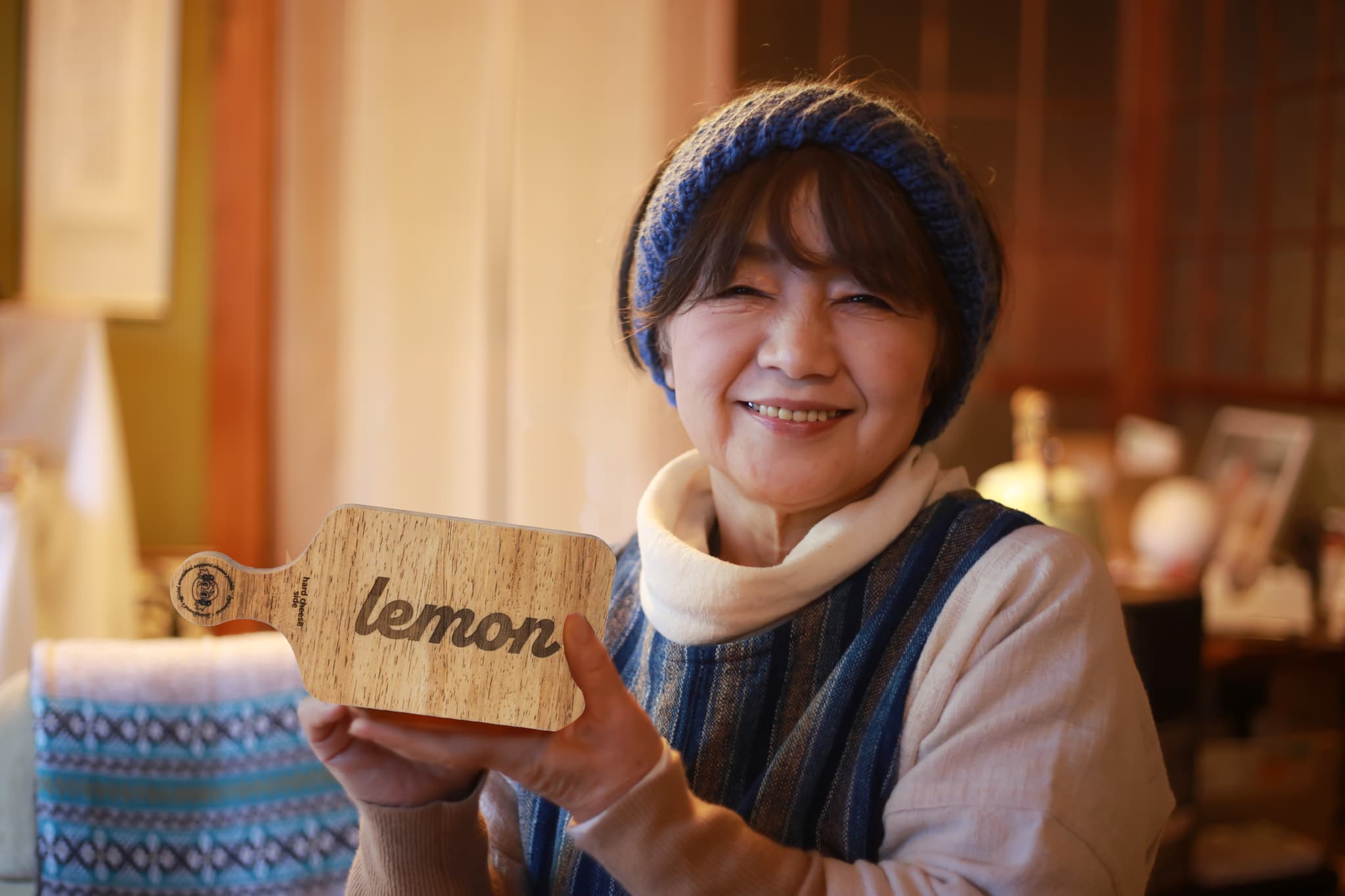 A old woman, holding up her FujoBoard.